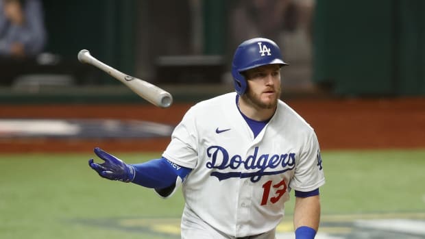 Oct 13, 2020; Arlington, Texas, USA; Los Angeles Dodgers first baseman Max Muncy (13) tosses his bat after hitting a two run home run during the ninth inning against the Atlanta Braves in game two of the 2020 NLCS at Globe Life Field. Mandatory Credit: Tim Heitman-USA TODAY Sports